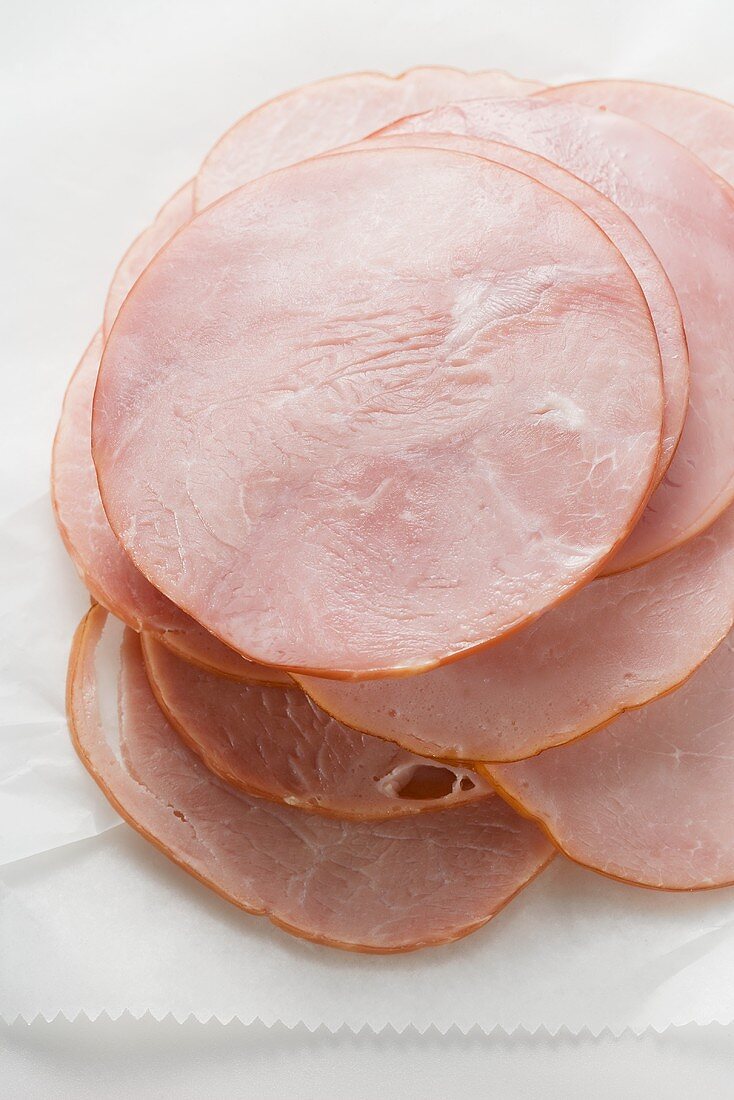 Slices of ham on paper