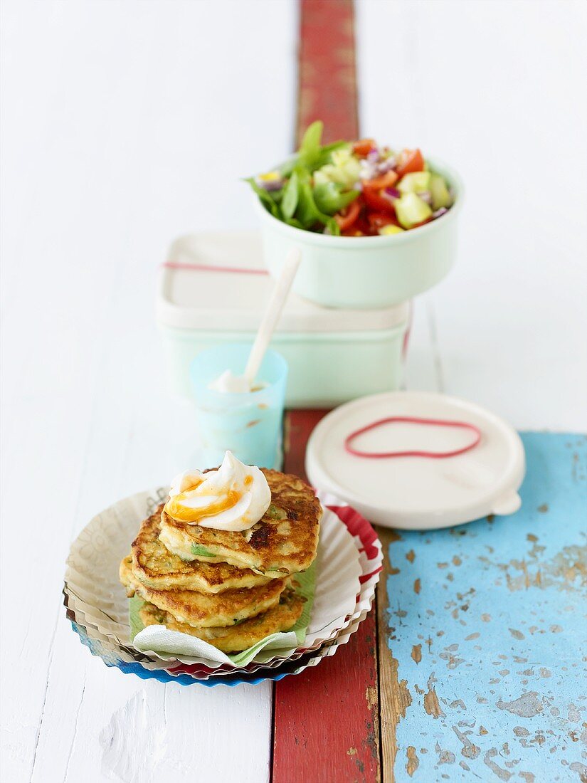 Bulgur pancakes with harissa yoghurt & tomato & cucumber salad