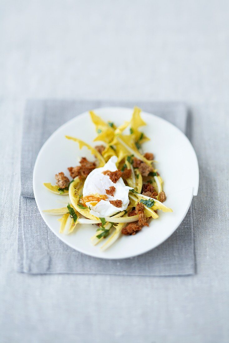 Poached egg on dandelion salad with croutons