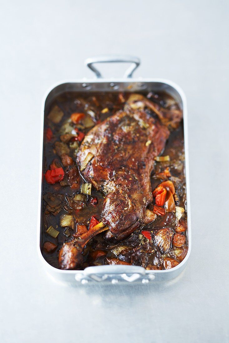 Braised shoulder of lamb in a roasting tin