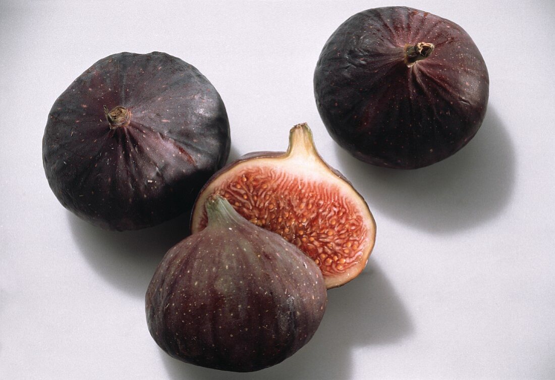 Two Whole Purple Figs; One Halved