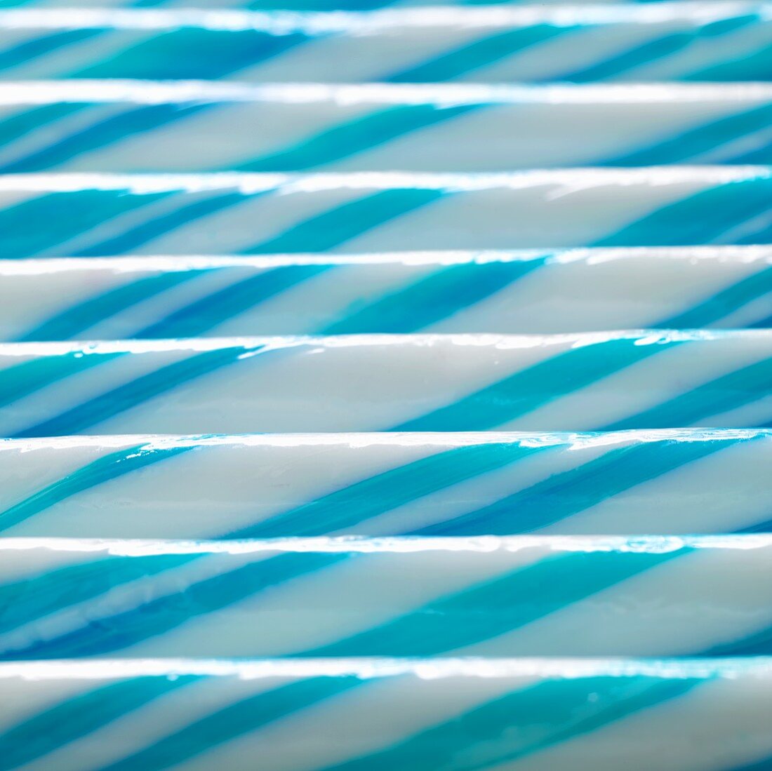 Blue and white striped sticks of rock (full-frame)