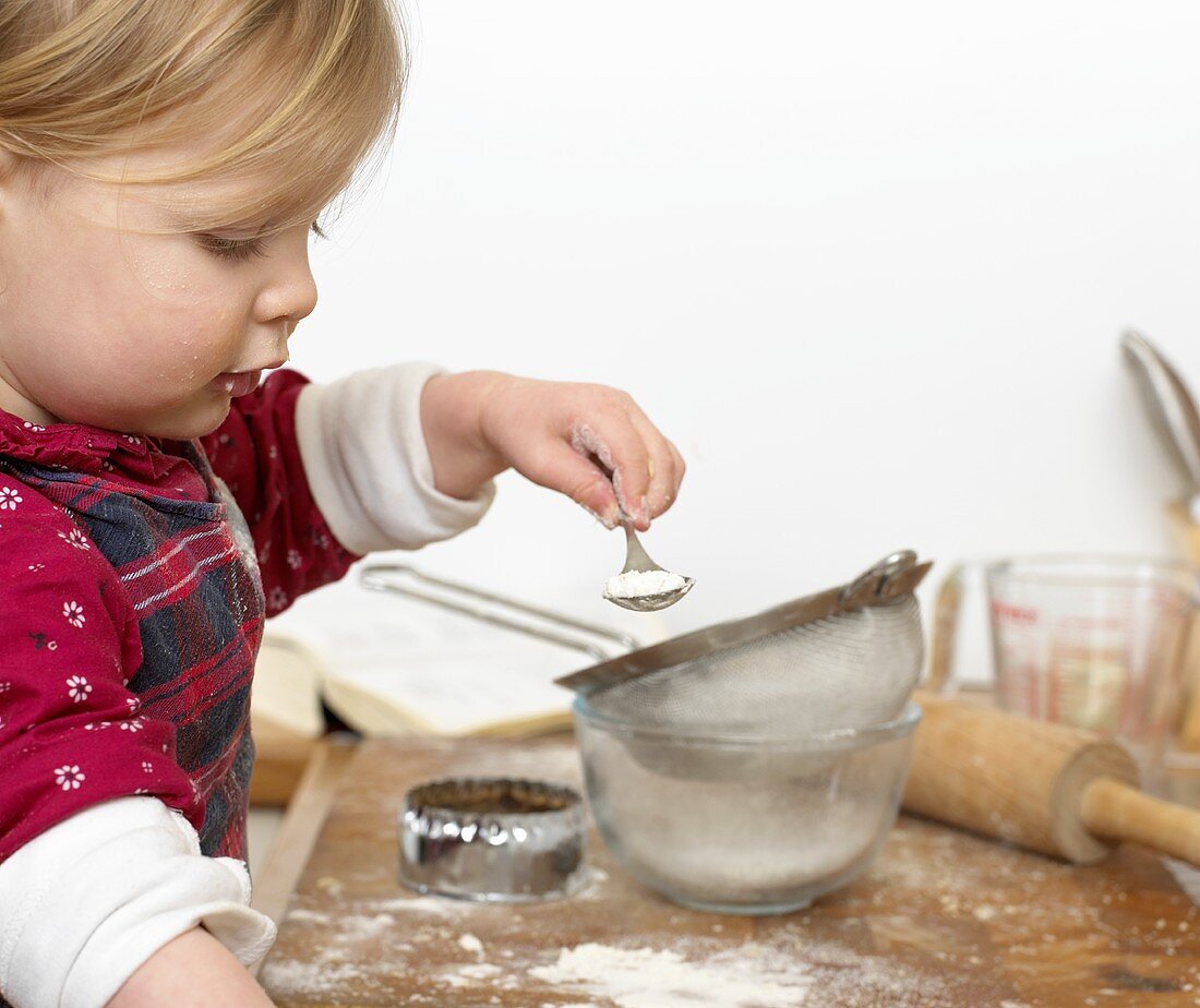 Girl sieving icing sugar