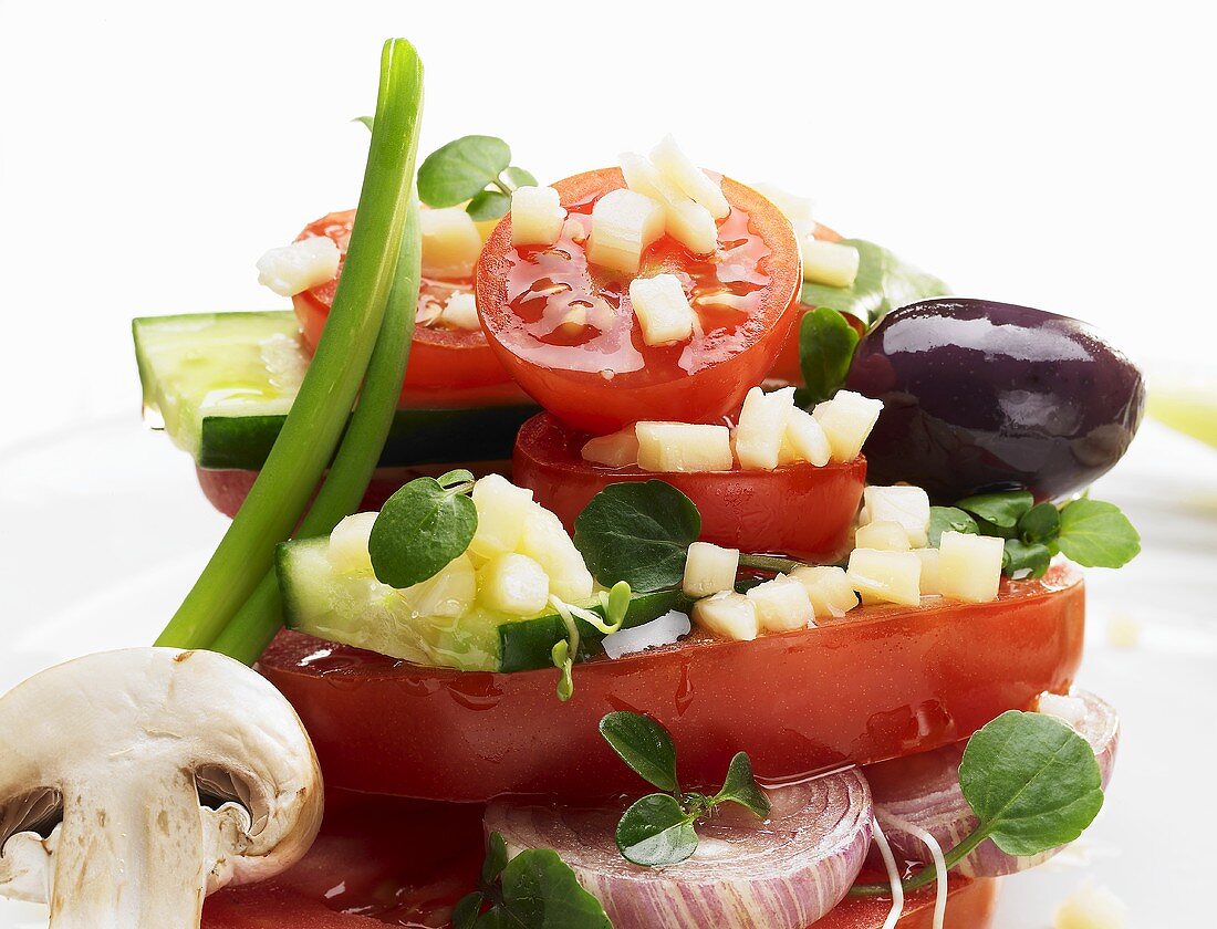 Tomato salad with cucumber, onion and cheese