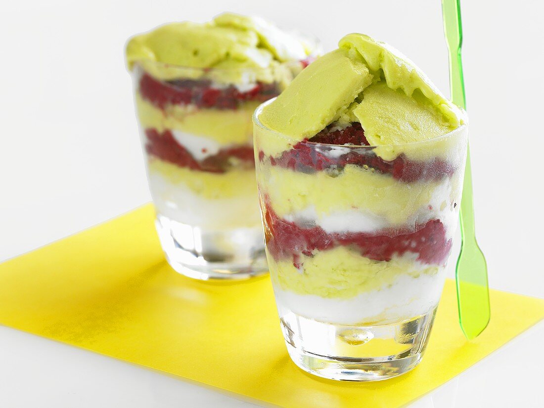 Coconut, basil and raspberry sorbets in two glasses