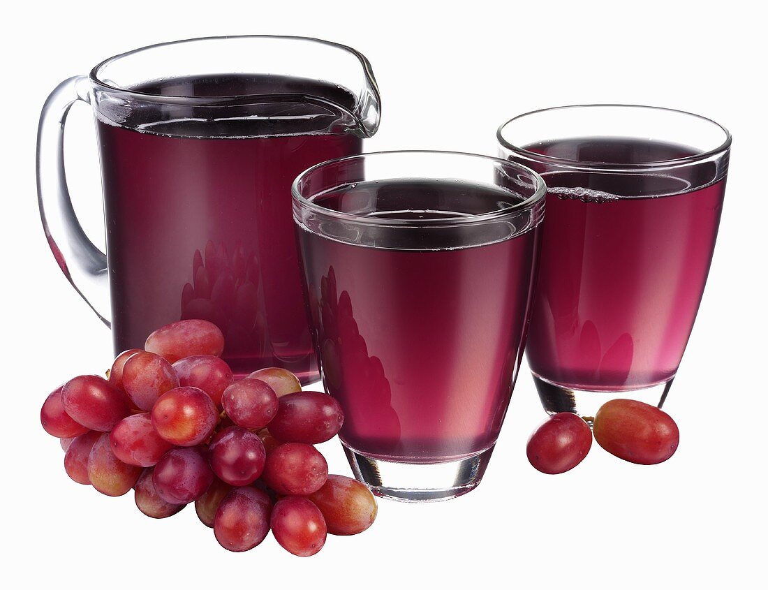 Grape juice in jug and two glasses and fresh grapes