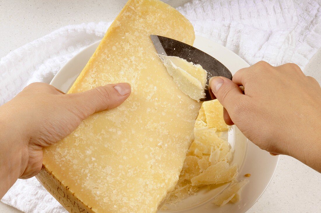 Woman shaving Parmesan with a Parmesan knife