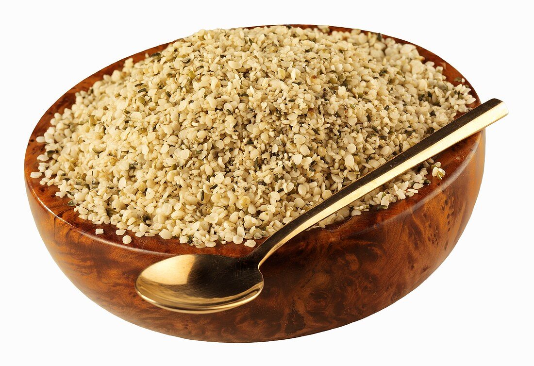 Hemp seeds in a wooden bowl with spoon
