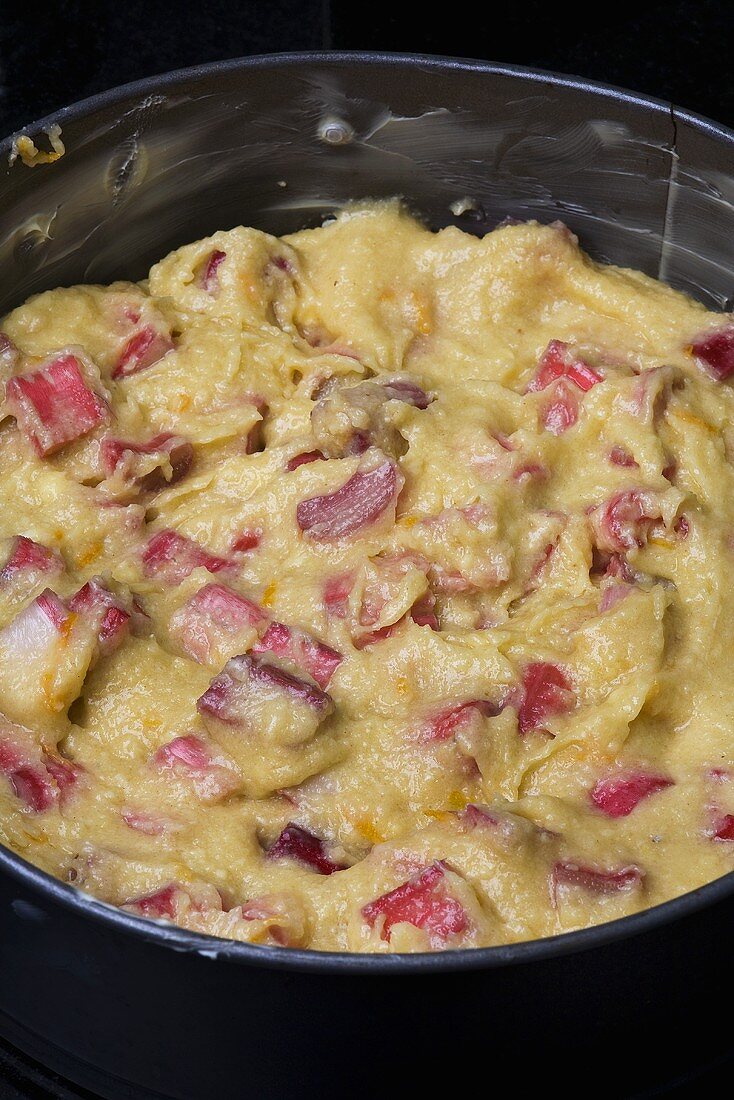 Unbaked rhubarb cake in the baking tin