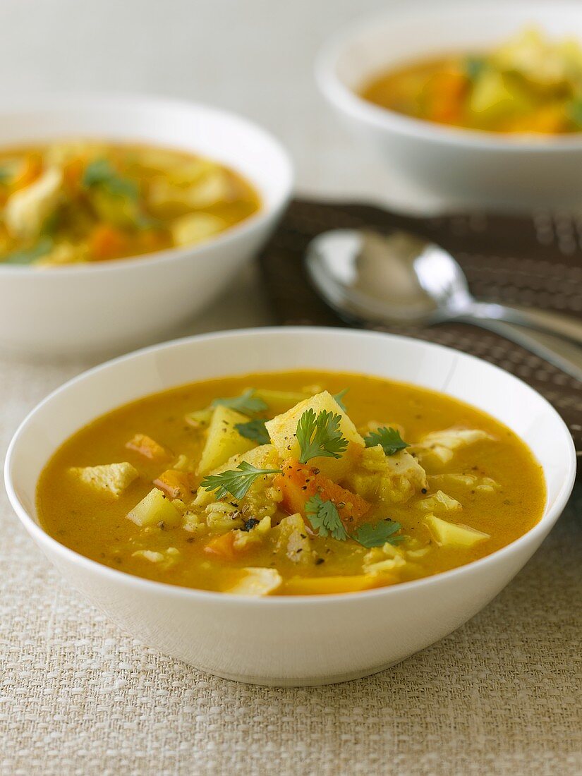 Three bowls of vegetable soup