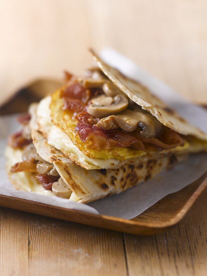 Bacon, egg and mushrooms in flatbread