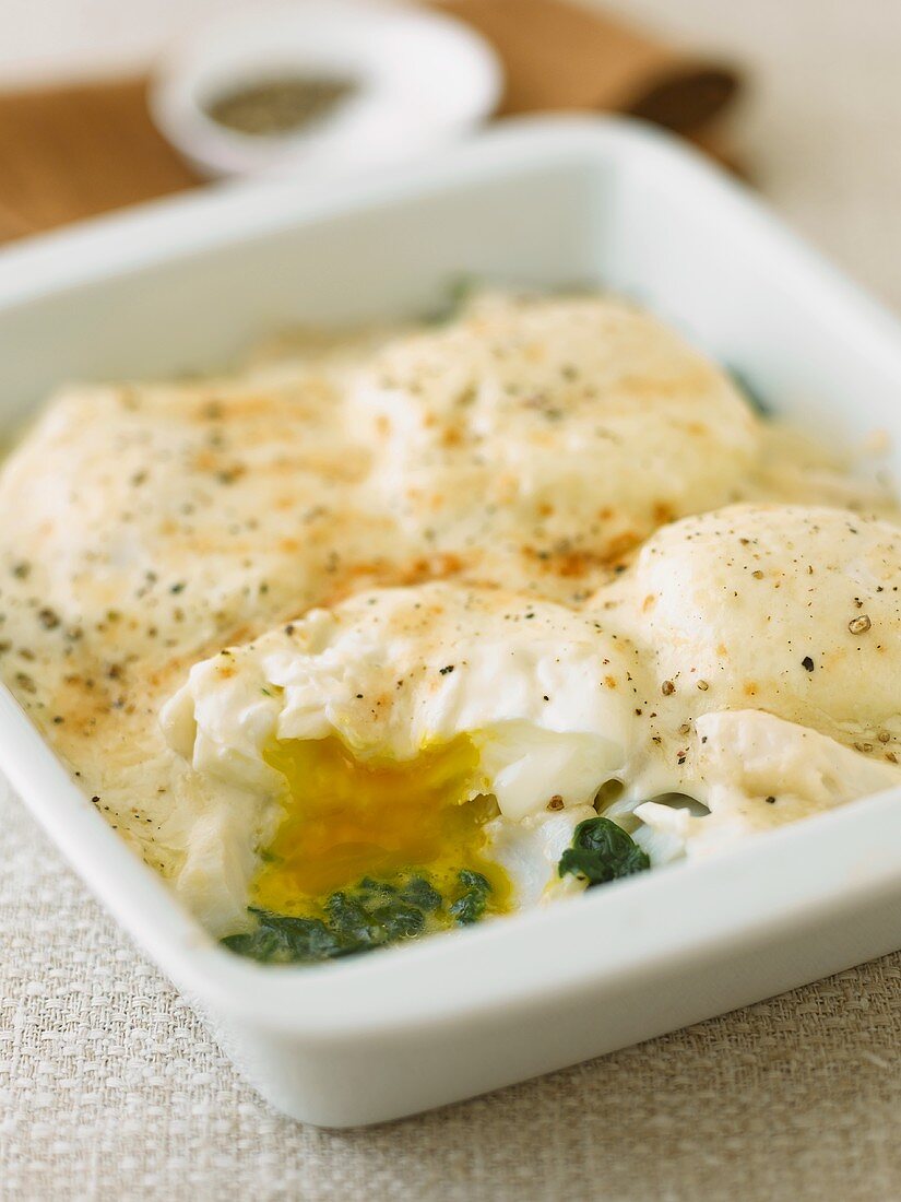 Baked eggs and fish fillet with spinach