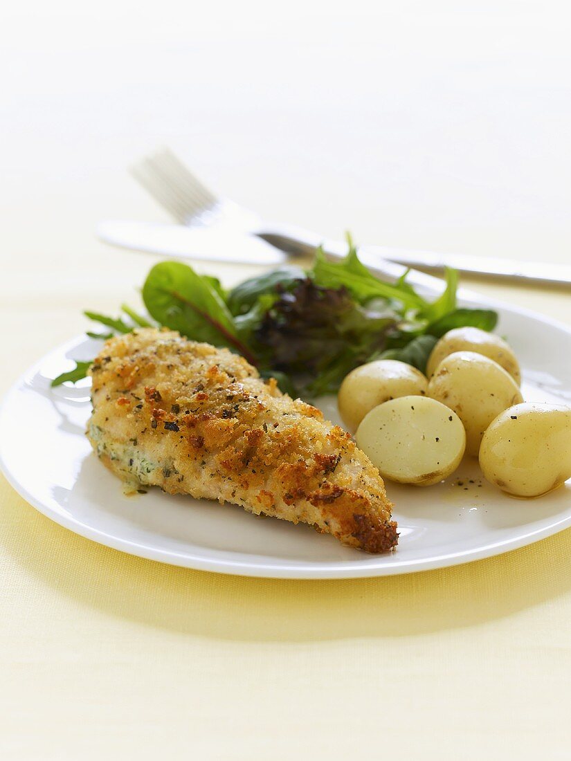 Spicy chicken breast with boiled potatoes and salad