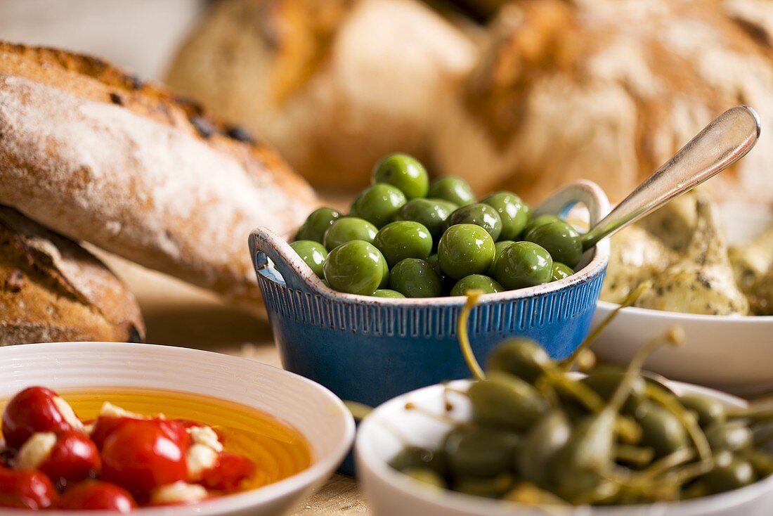 Still life with green olives in small bowl