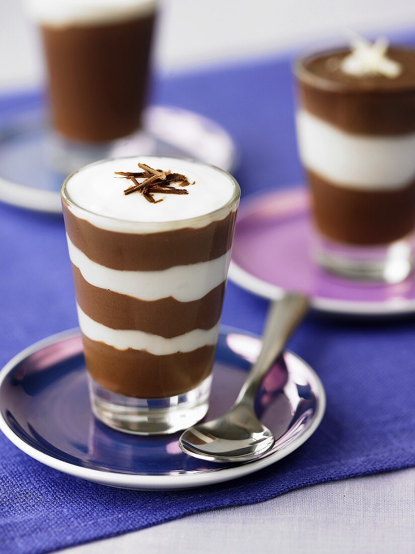 Layered chocolate mousse and cream in glasses