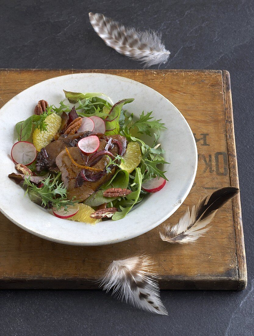 Salad leaves with pecans and fried goose liver