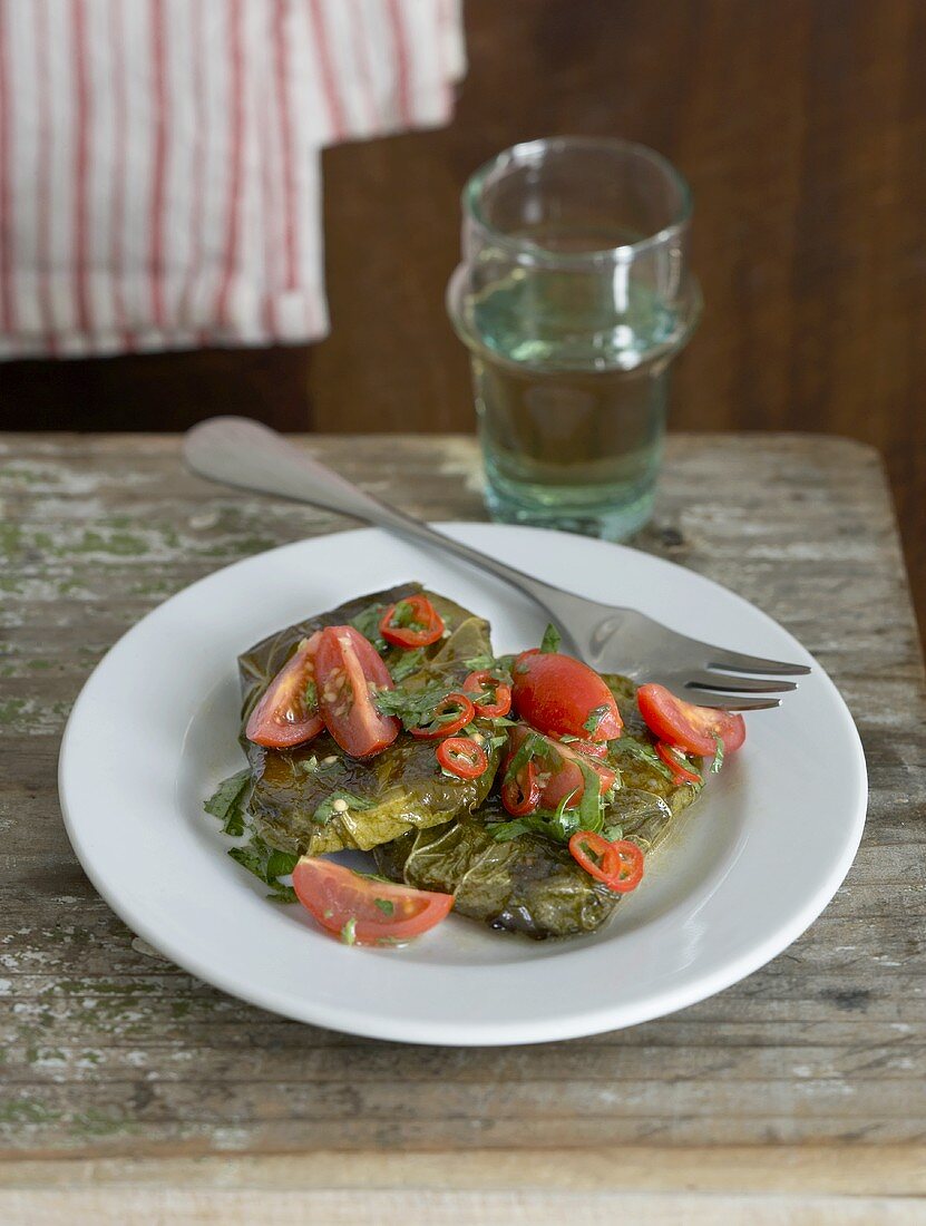 Halloumi with vine leaves marinated in oil with tomatoes