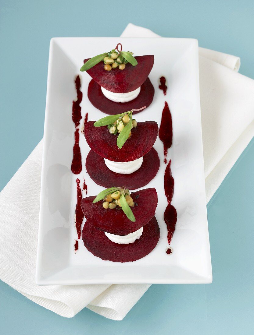 Beetroot and soft cheese tower with pine nuts