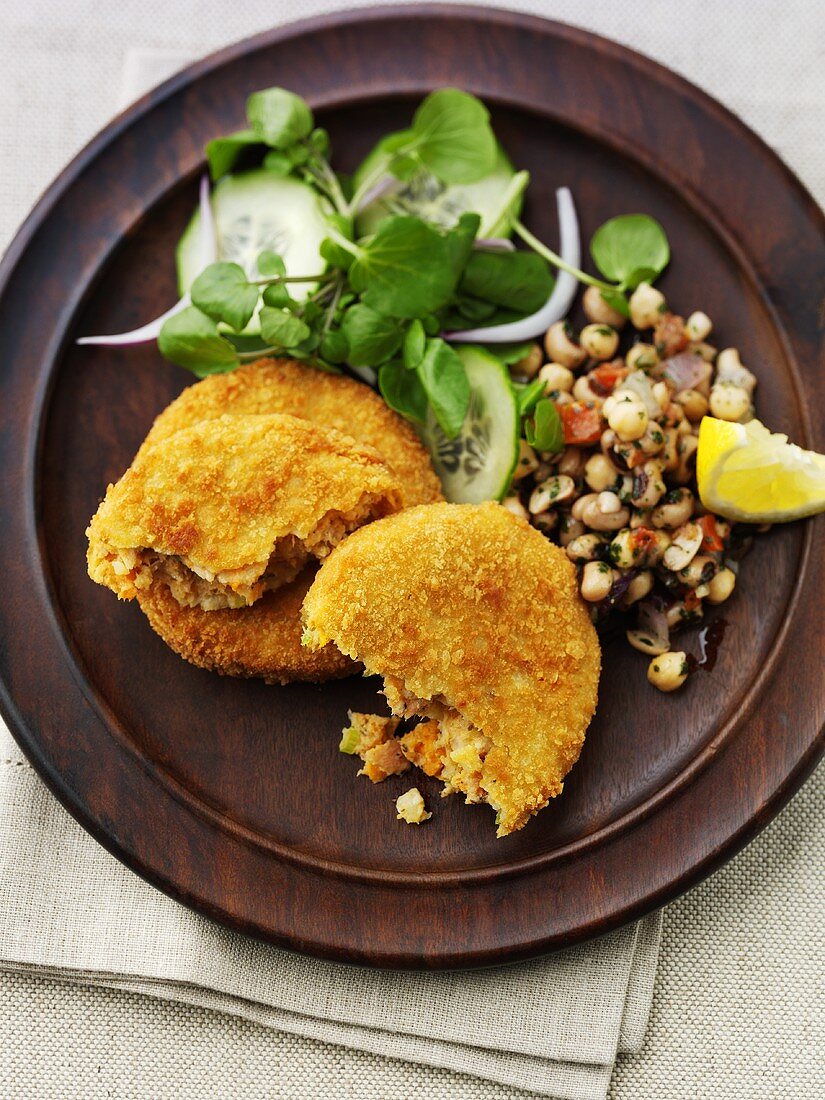 Breaded fish cakes with chick-pea salad