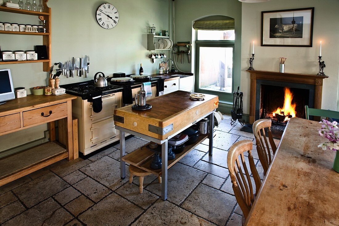 Kitchen with chopping block, dining table and open fire