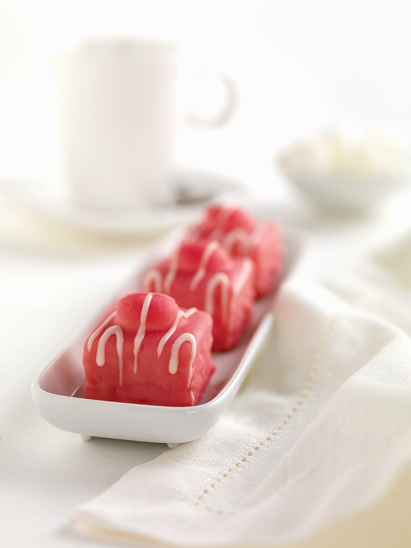 Three petit fours with raspberry icing