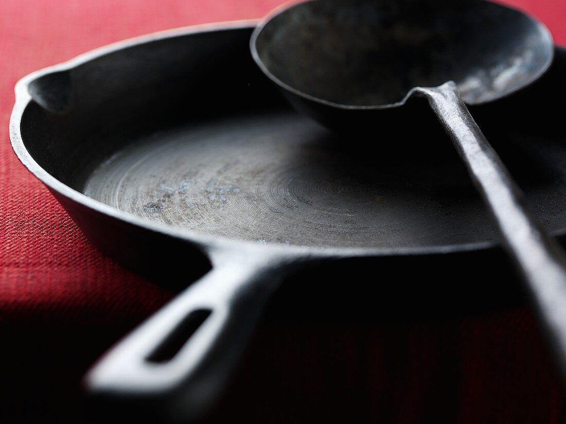 Cast-iron frying pan and soup ladle