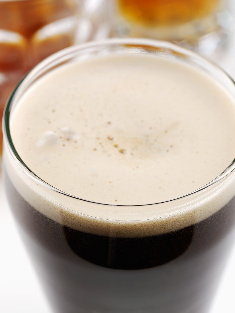 A glass of Guinness with a head of foam
