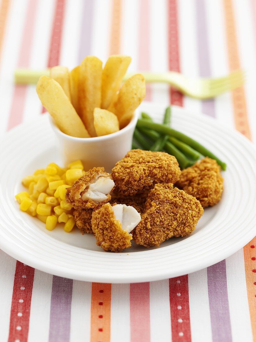Chicken nuggets with chips and vegetables