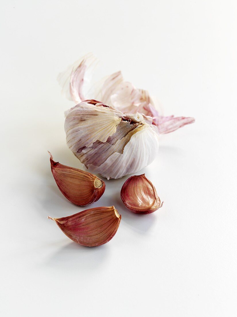 Cloves of garlic and garlic bulb with cloves removed