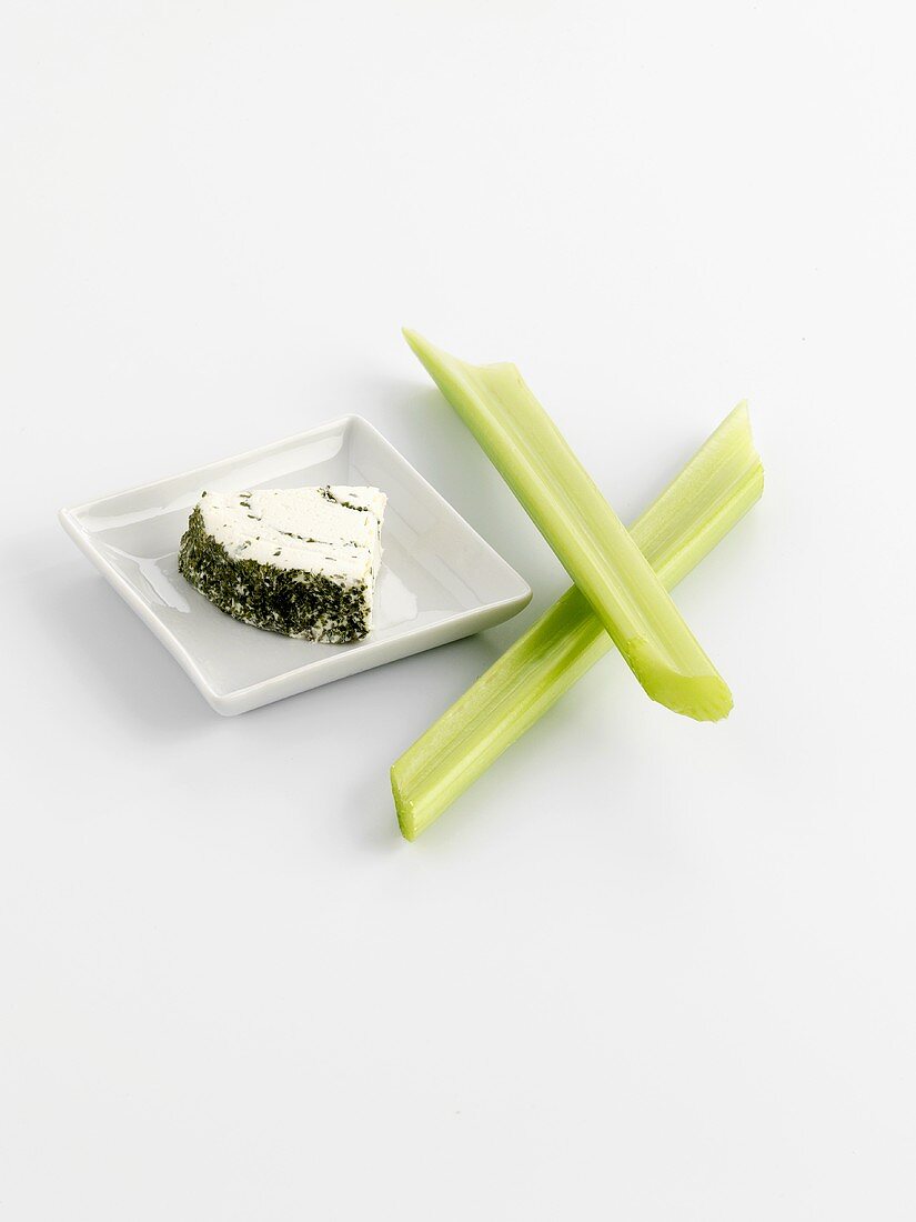 A piece of herb soft cheese and celery