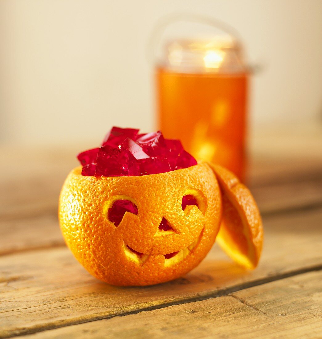 Cubes of fruit jelly in hollowed-out orange for Halloween