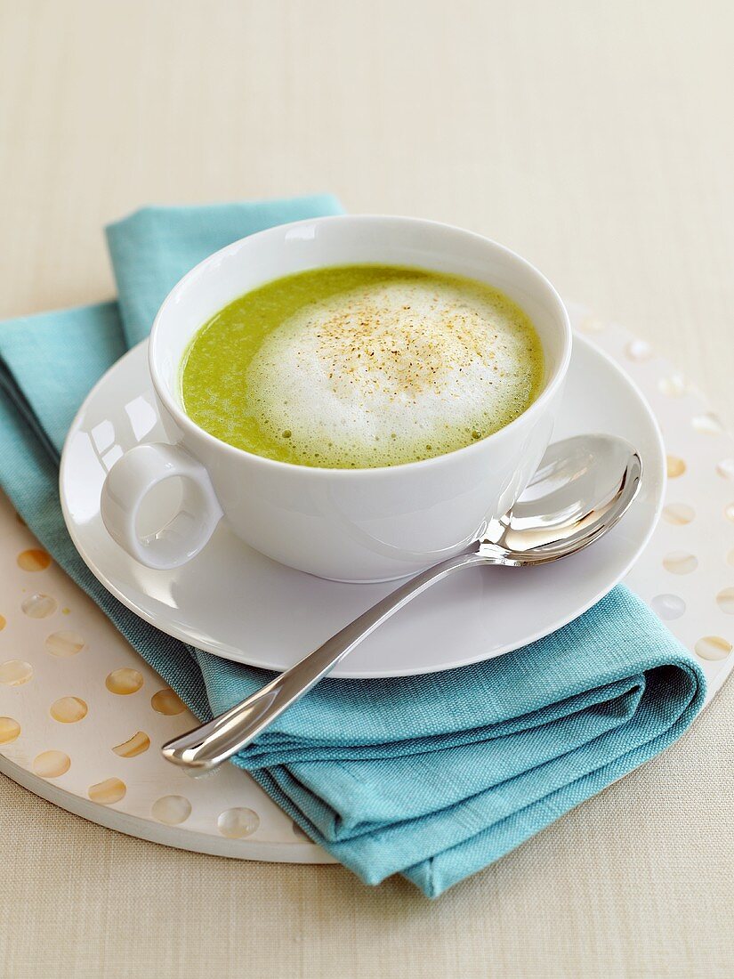 Cream of vegetable soup with milk foam in cup