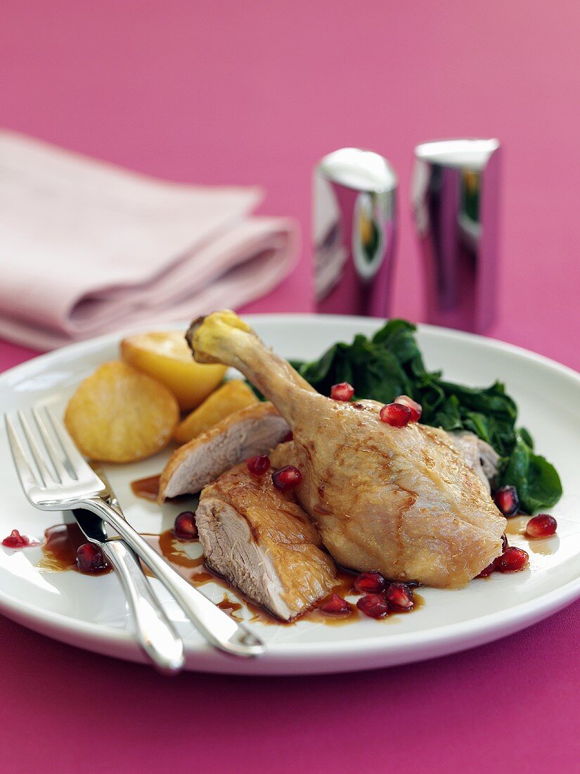Duck leg with pomegranate seeds