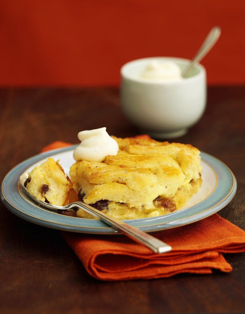 Bread and butter pudding with whipped cream (England)