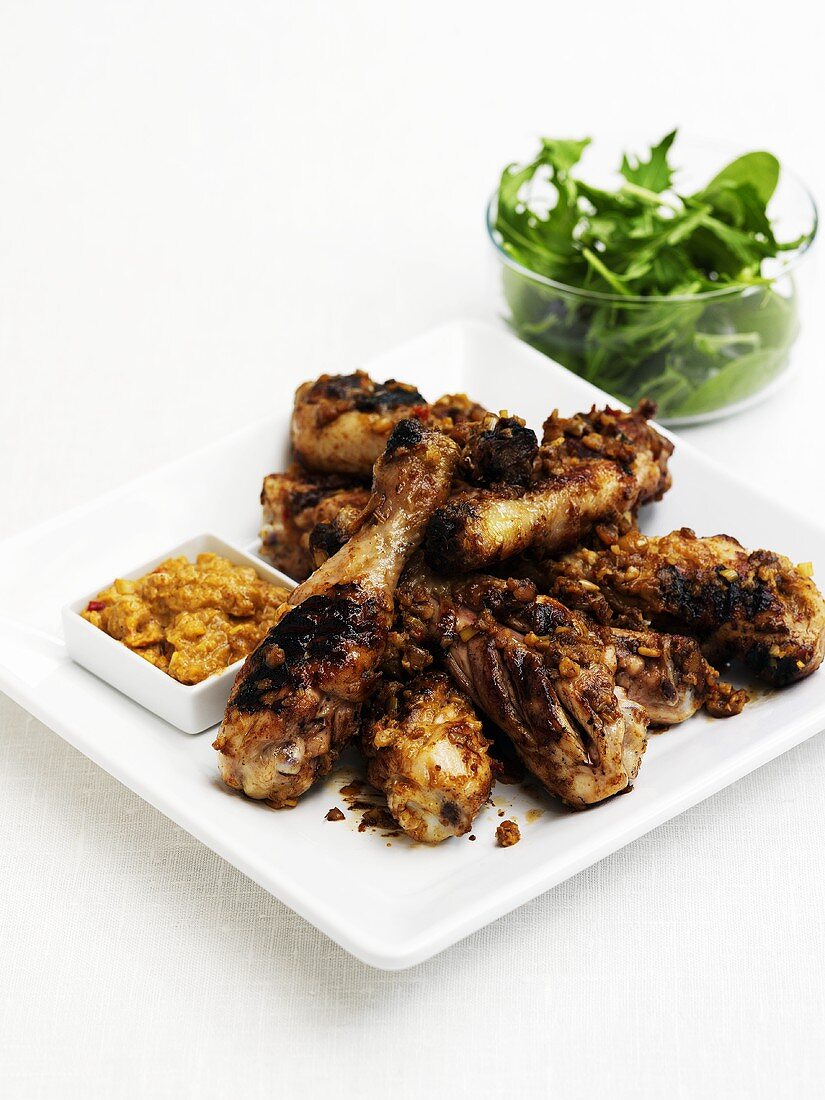 Chicken drumsticks with dip and looseleaf salad