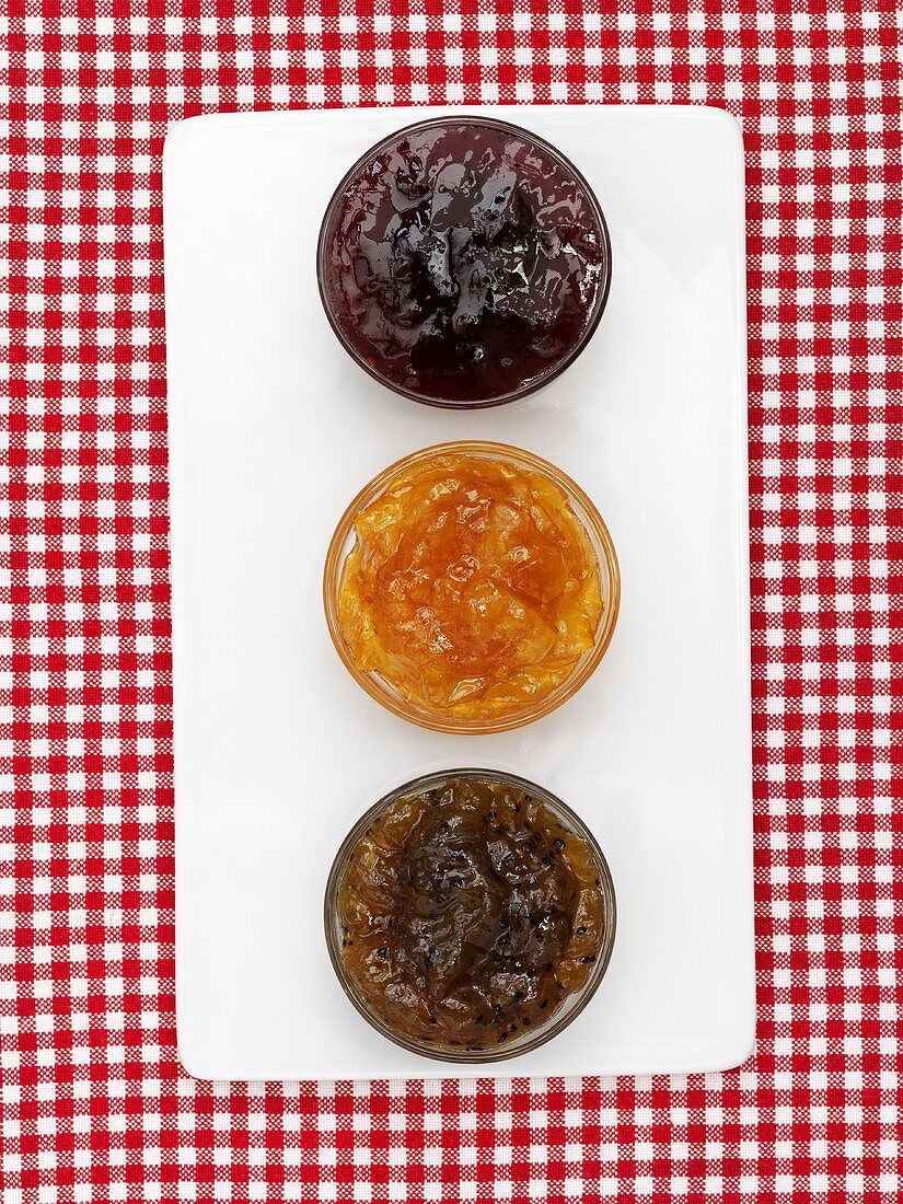 Three different jams in glass dishes (from above)