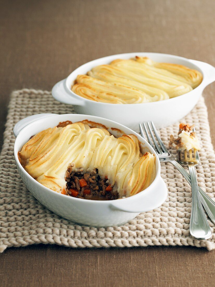 Two shepherds pies in casserole dishes (England)
