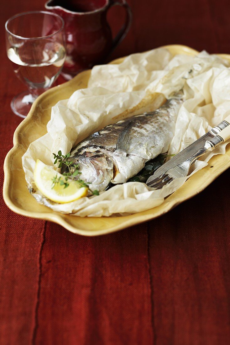 Stuffed sea bream with herbs baked in parchment paper
