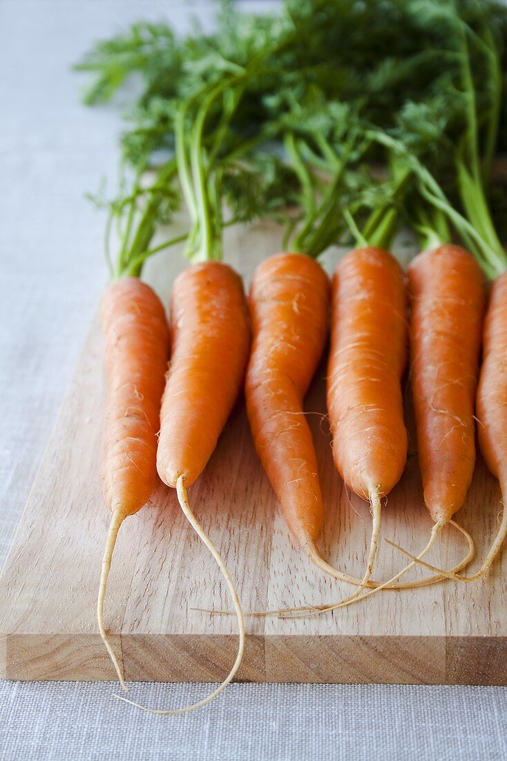 Fresh carrots on chopping board