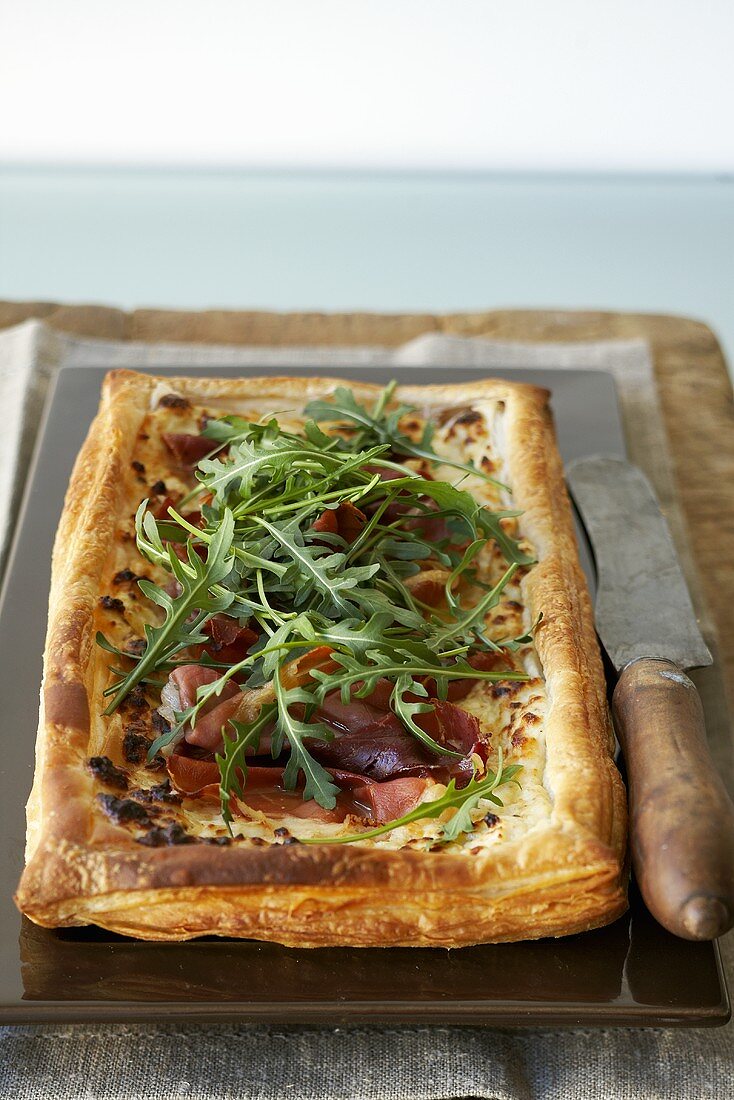 Parma ham and ricotta puff pastry tart with rocket