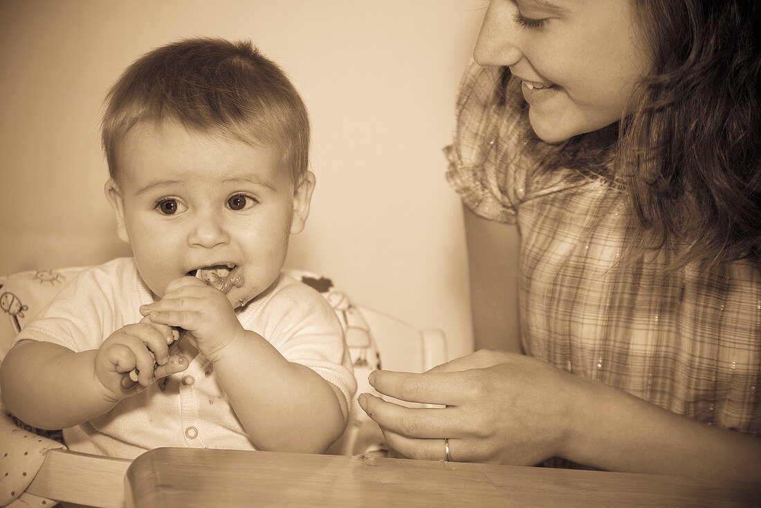 Mother feeding her baby (retro style)