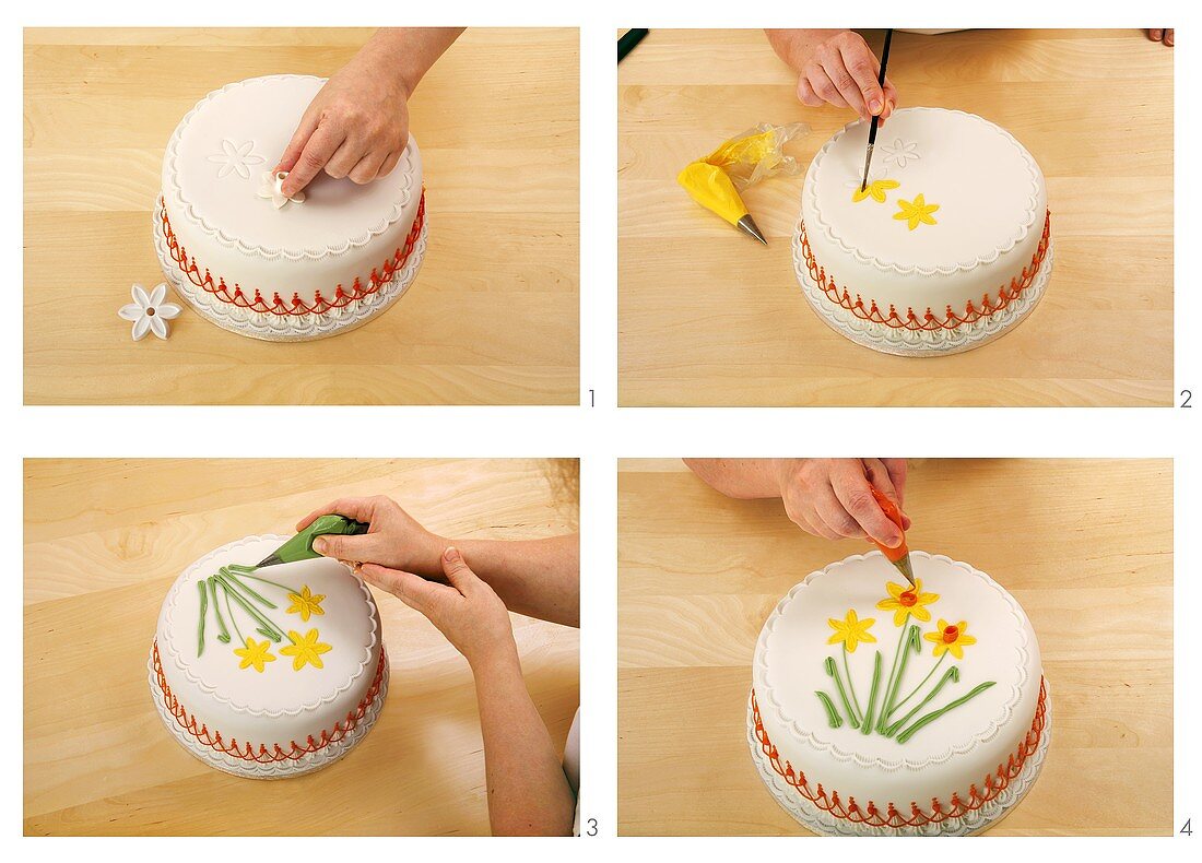 Decorating a fondant-covered cake with icing