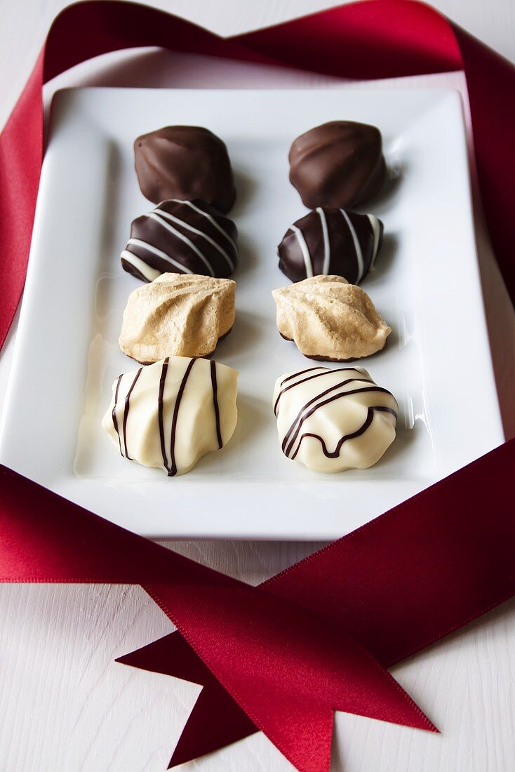 Meringue chocolates on white plate