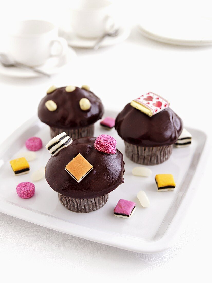 Muffins with chocolate icing and liquorice allsorts