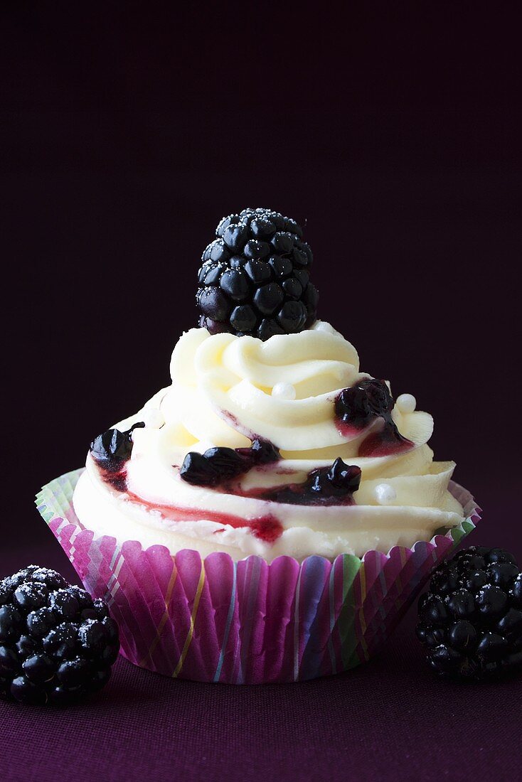 Cupcake with buttercream and blackberries