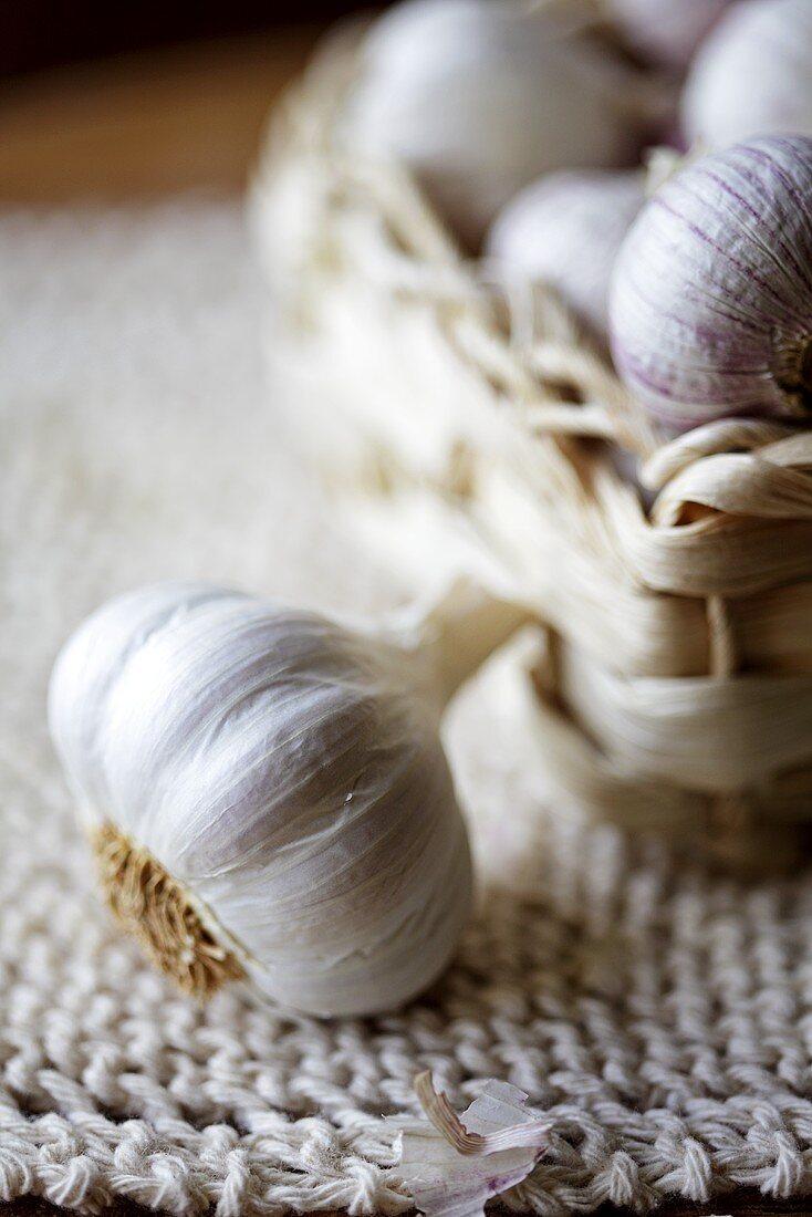 Garlic bulbs in and beside a small basket