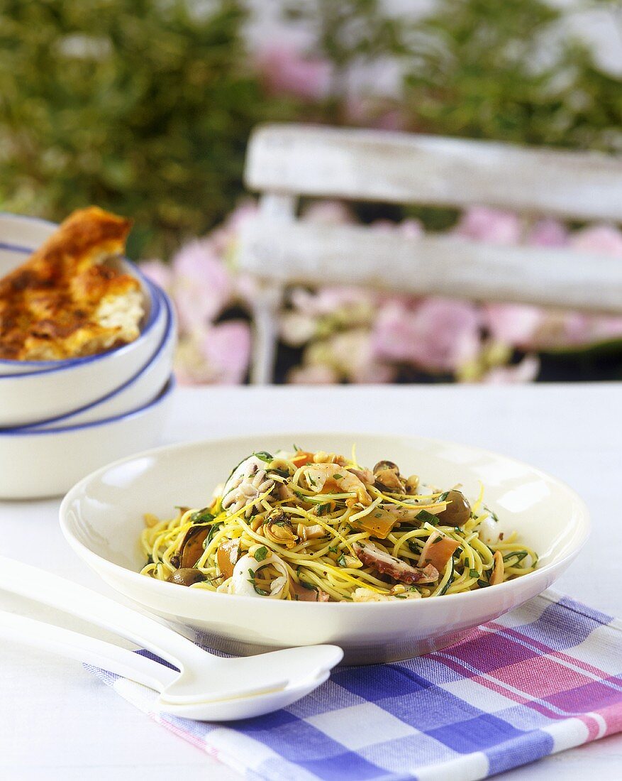 Spaghetti with seafood, rocket and pine nuts