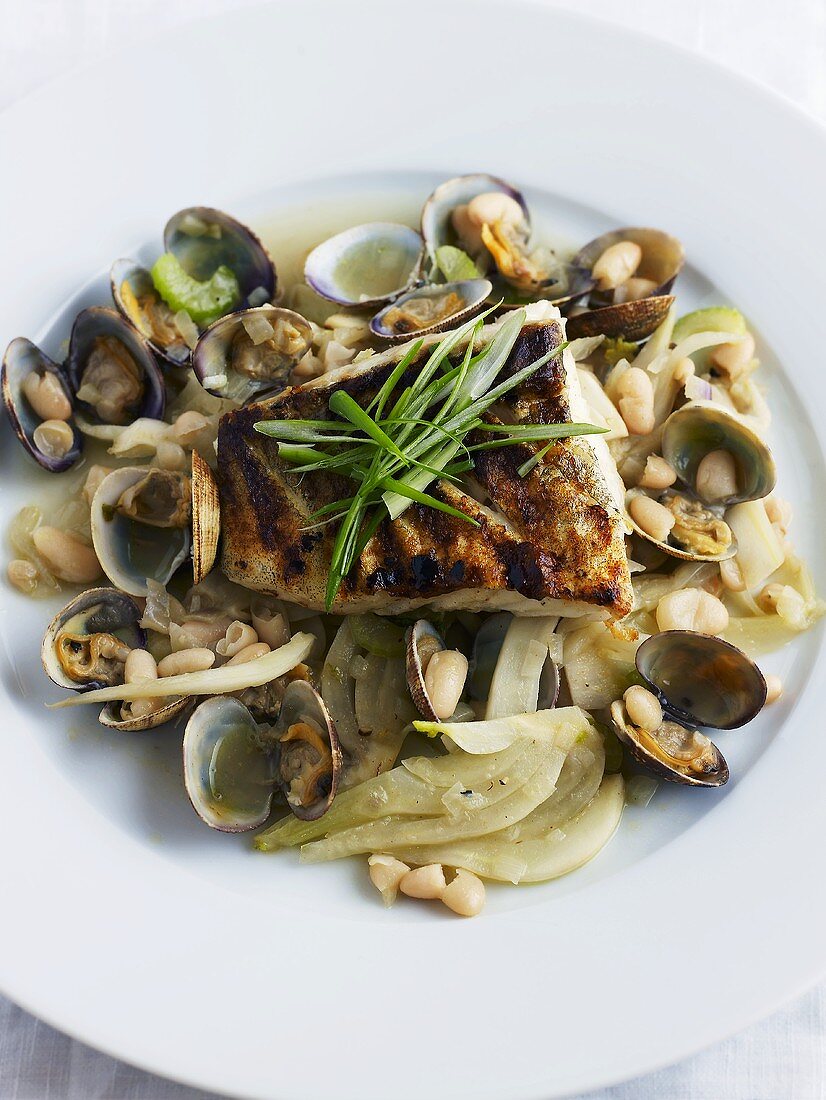 Fried cod on fennel, beans and shellfish