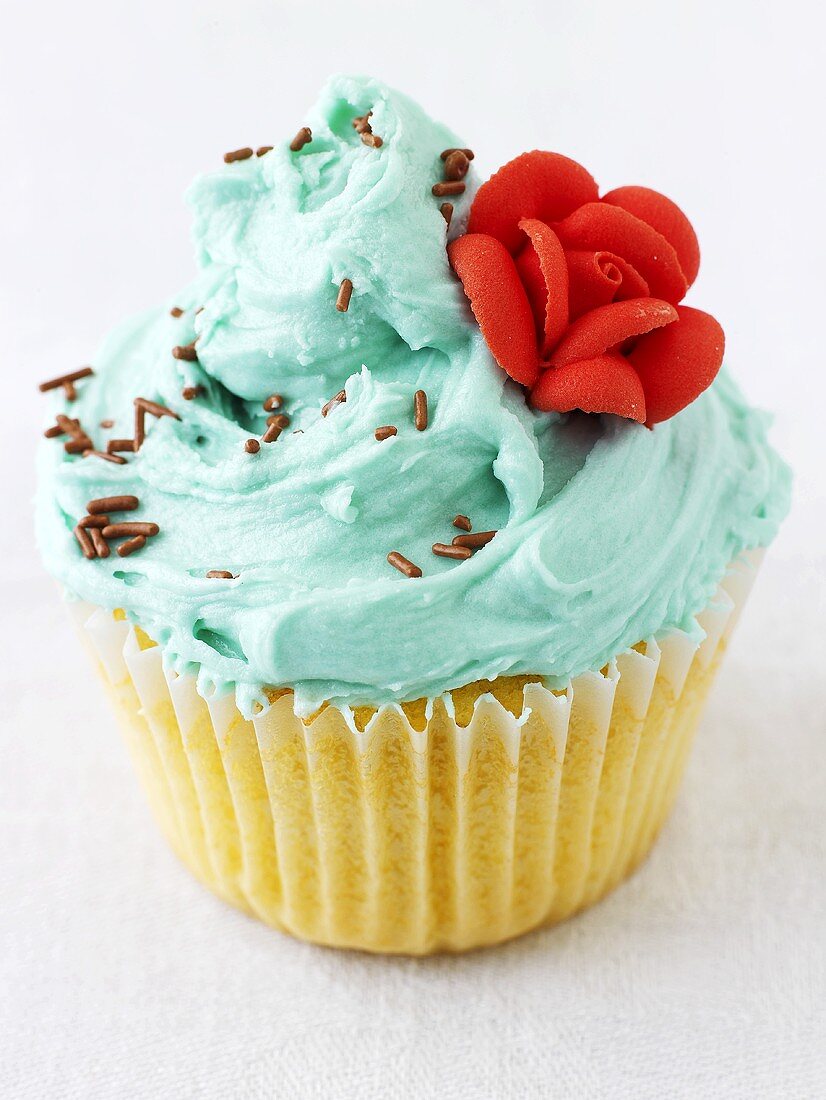 Cupcake with turquoise icing and sugar rose