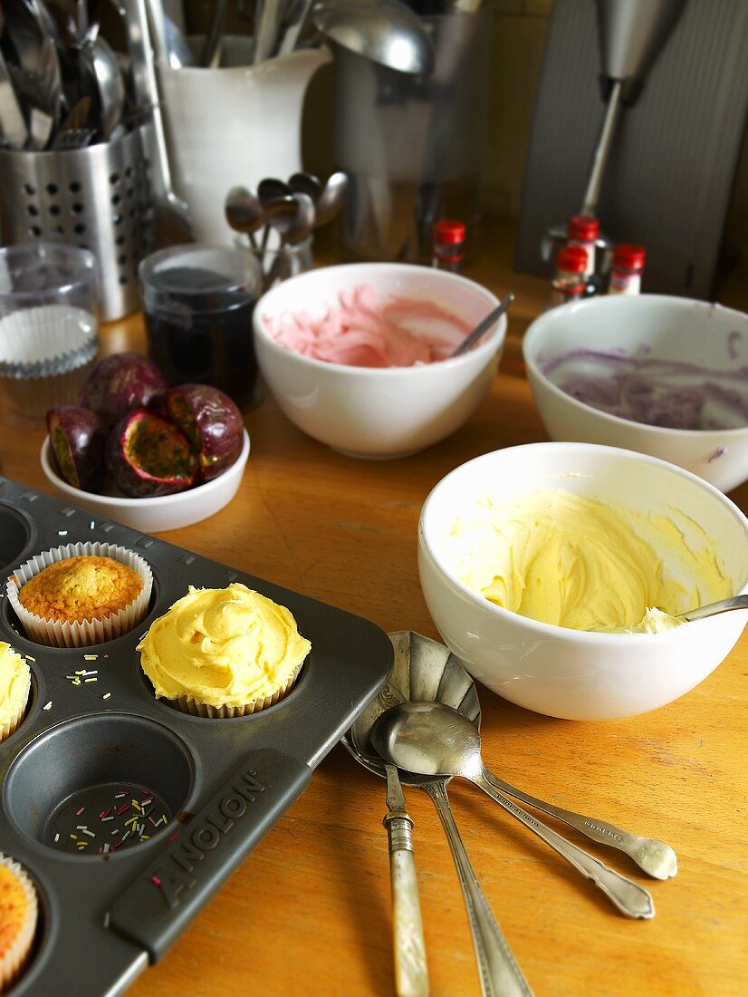 Cupcakes with bowls of different icing